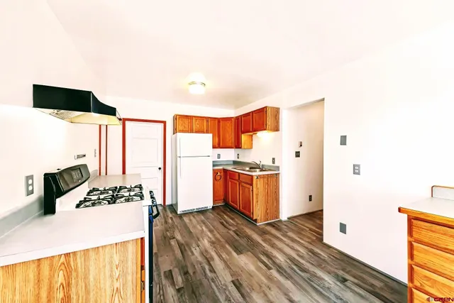 a kitchen with a sink and a refrigerator