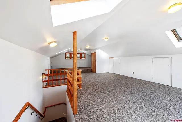 a view of a livingroom with a furniture and staircase