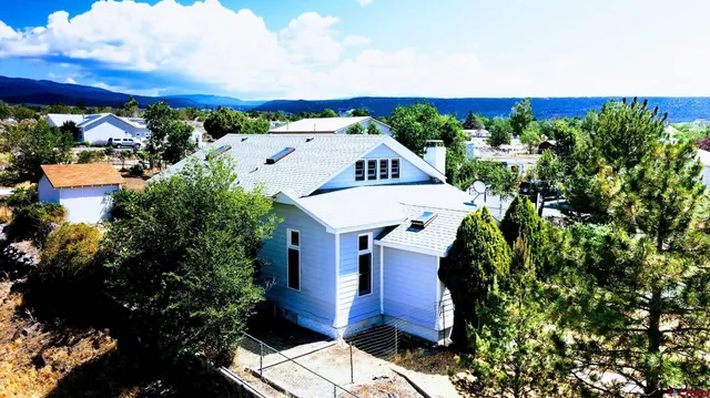 an aerial view of a house with a swimming pool patio and outdoor seating