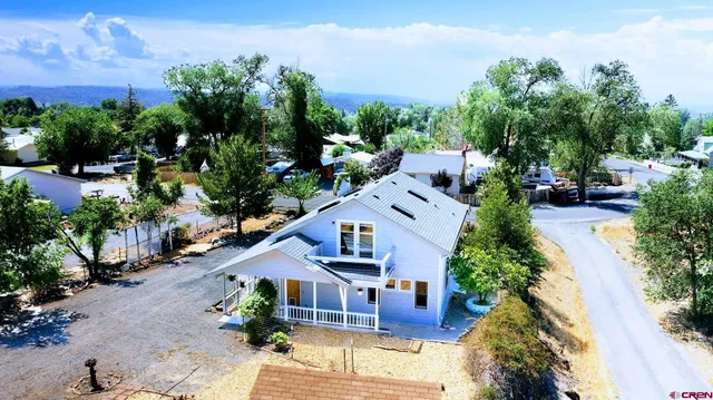 an aerial view of a house with garden space and street view