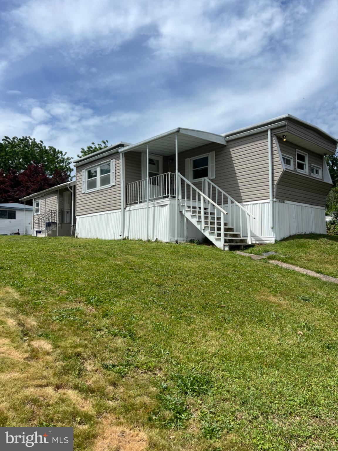 1302 Gibson Road, Unit 152 Bensalem, PA 19020 - Photo 15 of 18 a front view of a house with a yard