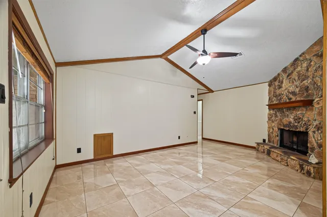 a view of an empty room with a fireplace