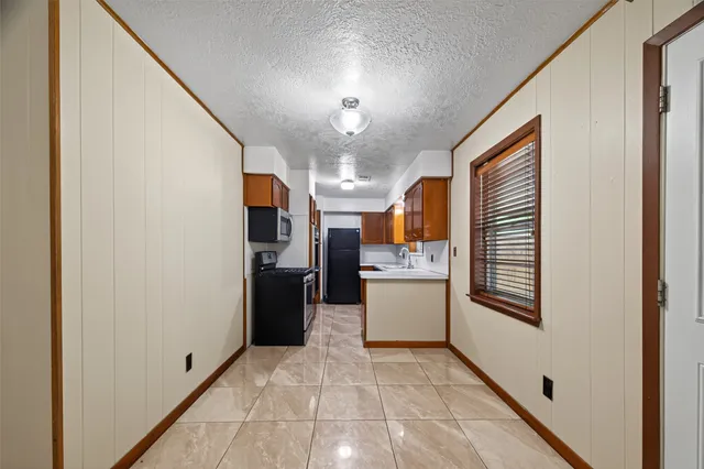 a view of a hallway with a kitchen