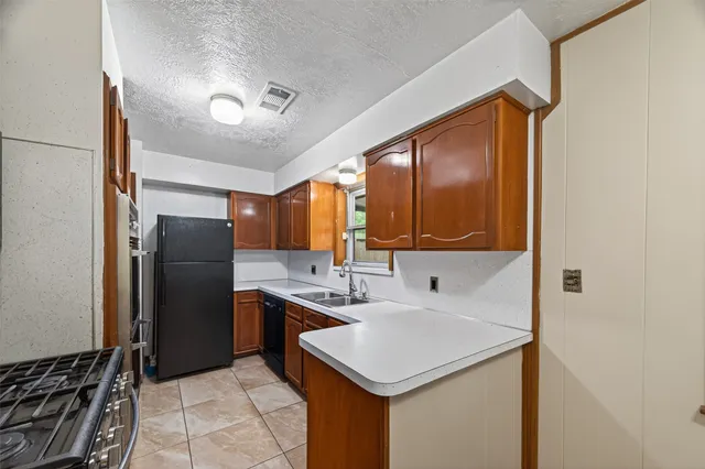 a kitchen with a sink and a refrigerator