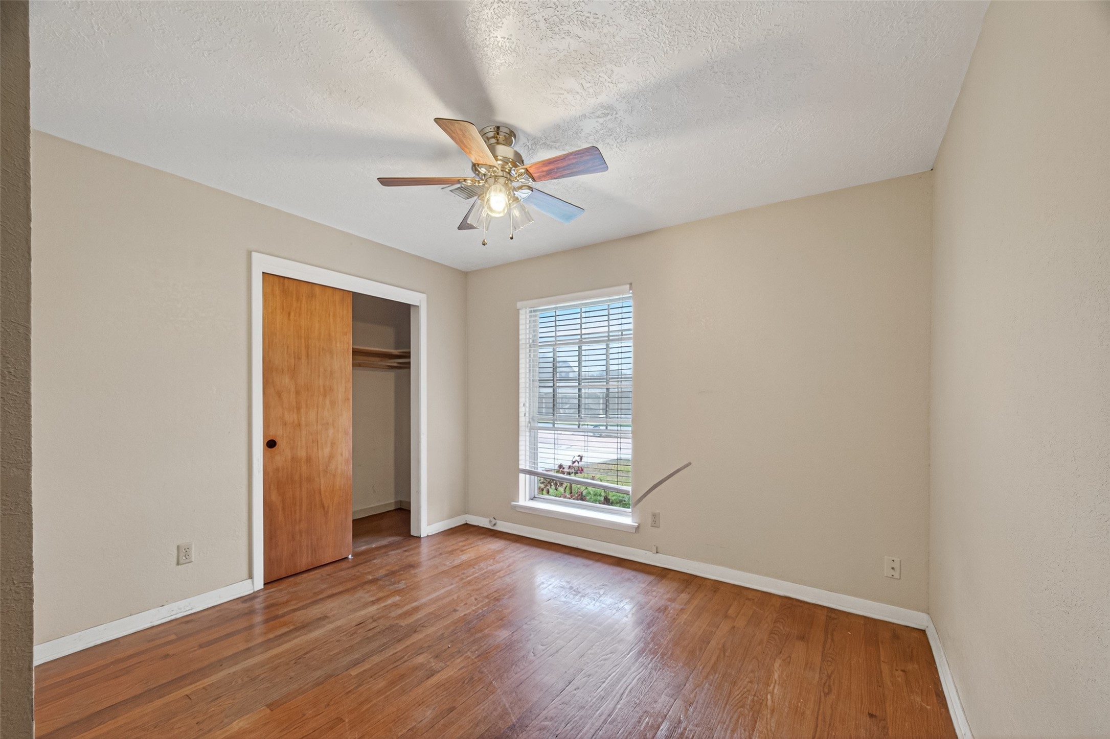 2609 Raspberry Lane Pasadena, TX 77502 - Photo 21 of 40 an empty room with wooden floor and windows