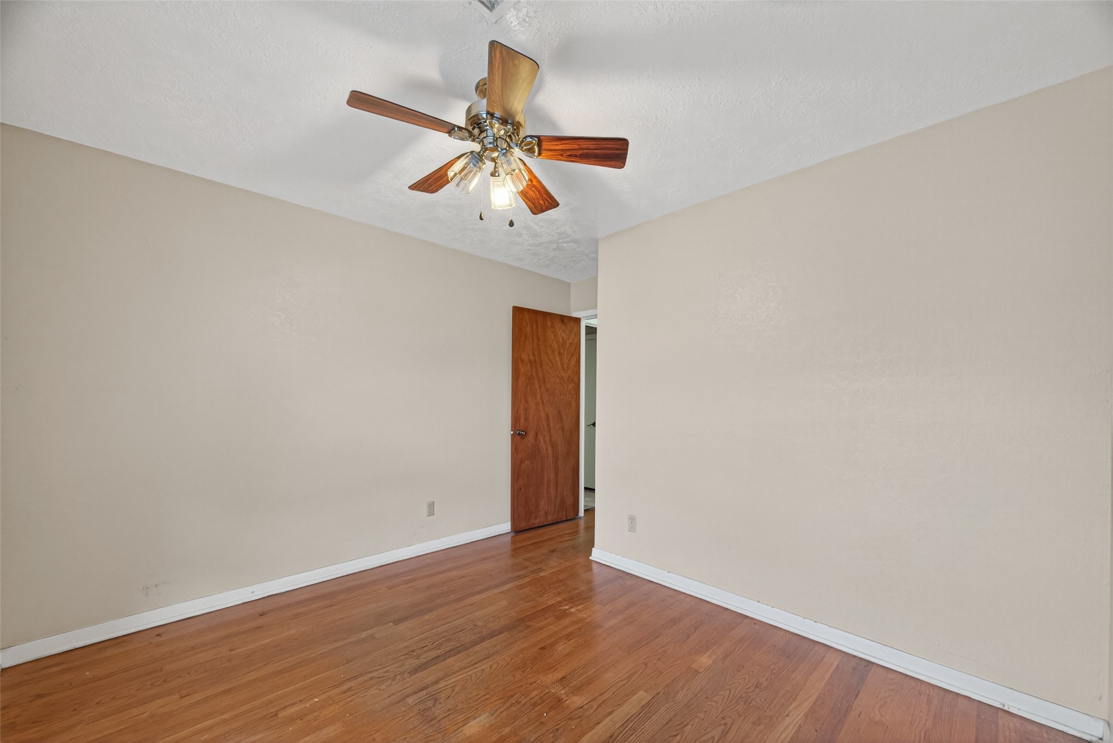 2609 Raspberry Lane Pasadena, TX 77502 - Photo 23 of 40 an empty room with wooden floor closet and ceiling fan