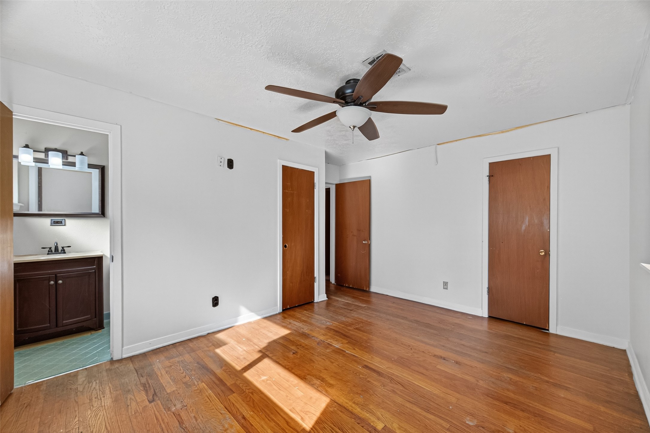 2609 Raspberry Lane Pasadena, TX 77502 - Photo 32 of 40 a view of empty room with wooden floor and ceiling fan