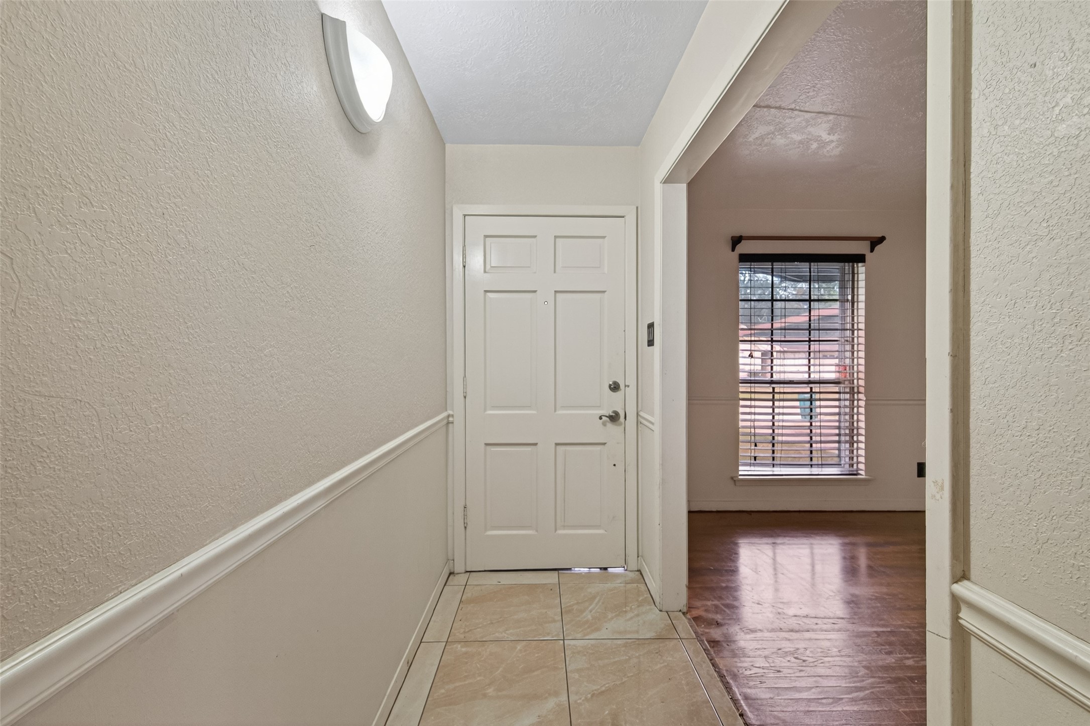 2609 Raspberry Lane Pasadena, TX 77502 - Photo 5 of 40 a view of an empty room with wooden floor and a window