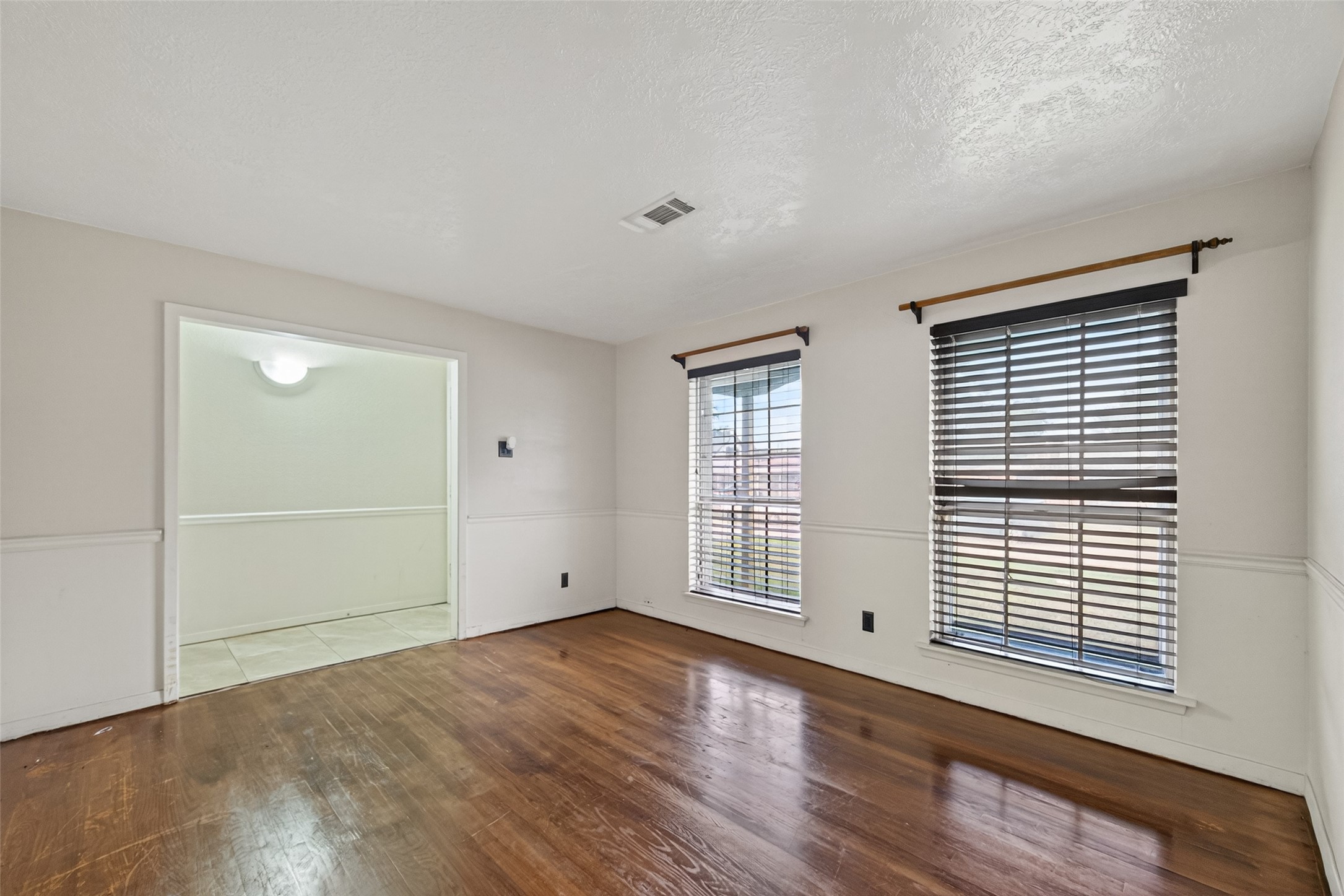 2609 Raspberry Lane Pasadena, TX 77502 - Photo 7 of 40 an empty room with wooden floor and windows