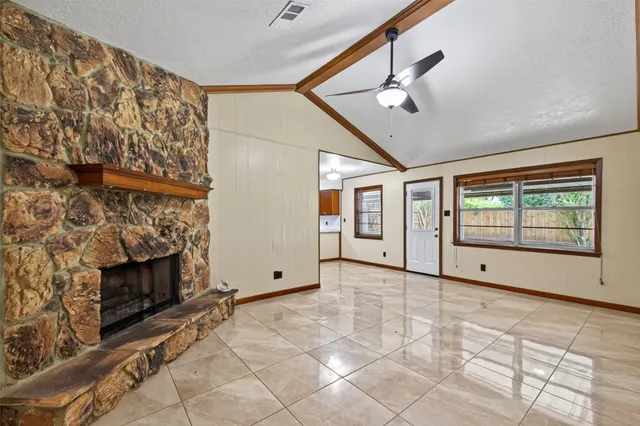 a view of an empty room with glass door and balcony