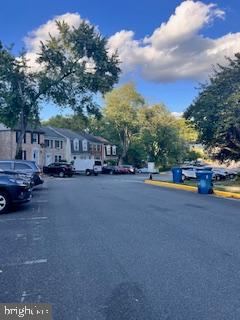 9218 Sprucewood Road Burke, VA 22015 - Photo 18 of 33 Charming neighborhood under a bright sky.