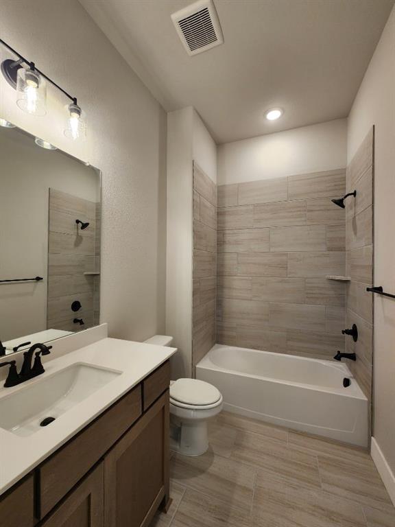 2305 Gypsum Street Krum, TX 76249 - Photo 8 of 22 Bathroom featuring a single vanity with wood-finish cabinetry and a white countertop