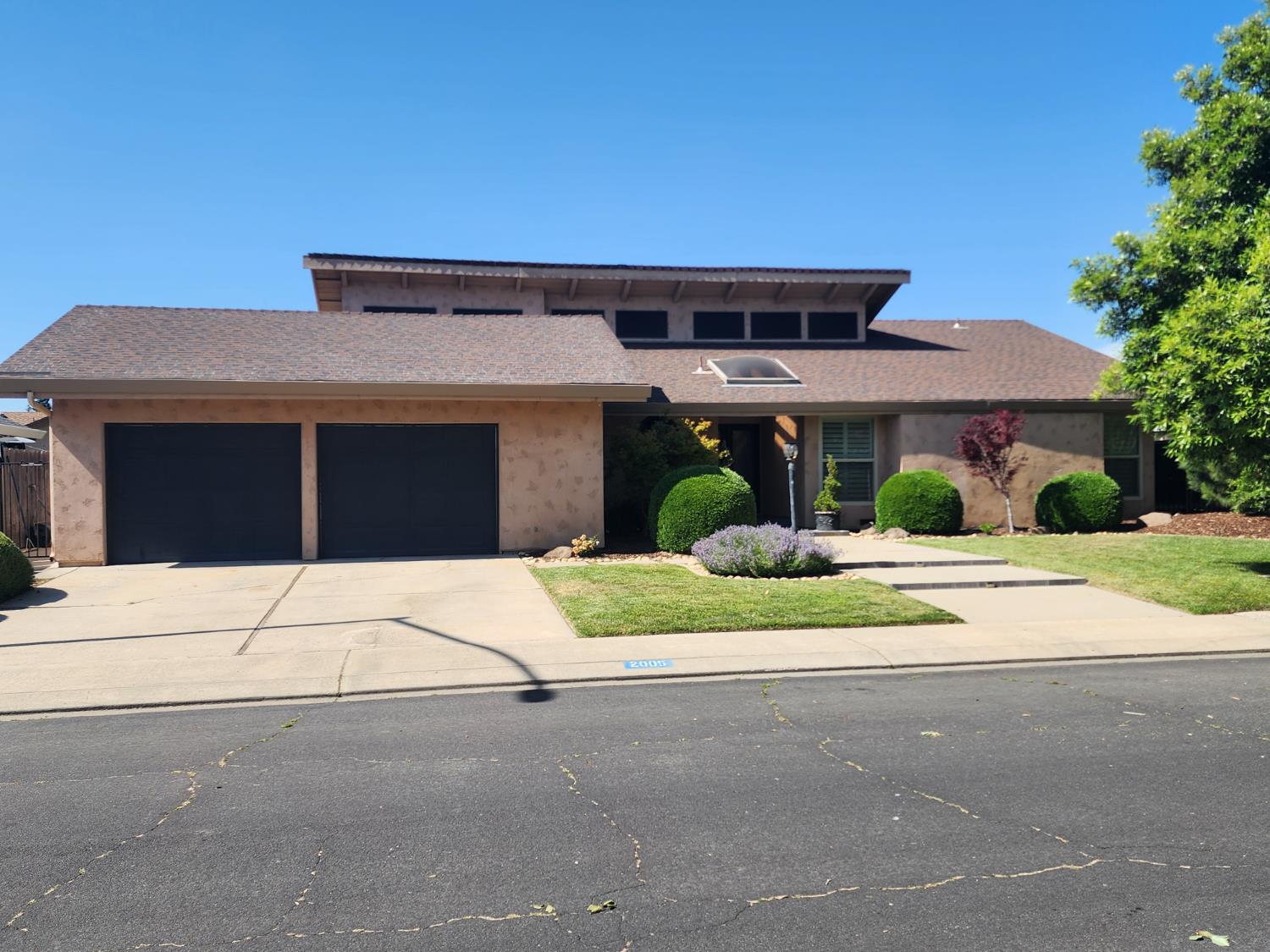 2005 Sandpoint Drive Modesto, CA 95358 - Photo 1 of 1 a house with a yard and a car parked in front of it