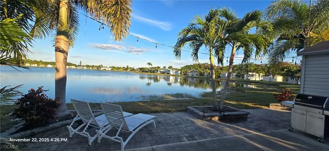 a view of a lake with a table and chairs