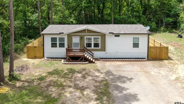 a aerial view of a house next to a yard