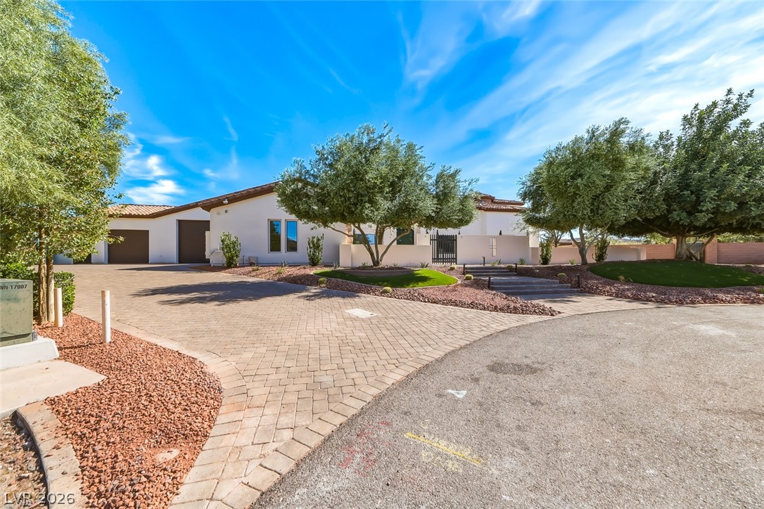 1140 Julie Road Henderson, NV 89002 - Photo 13 of 38 A graceful paved driveway leads to this desert dwelling hideaway with lush landscaping and mature trees.