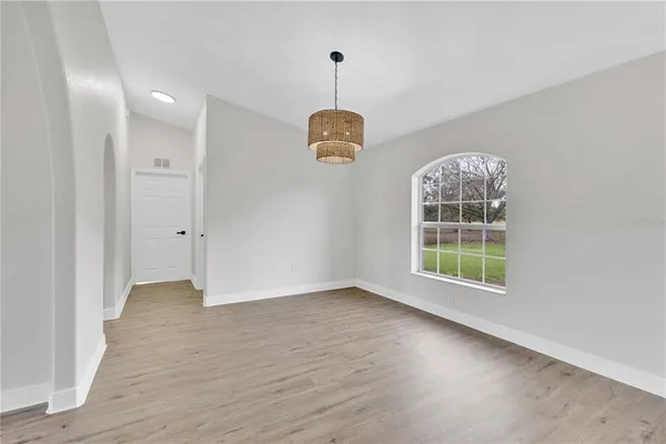 an empty room with windows and entrance