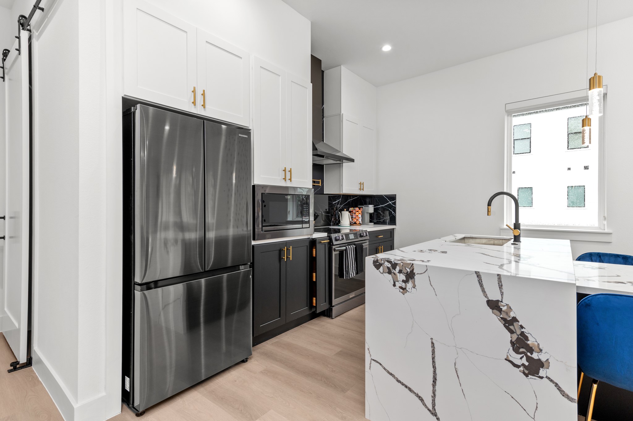 3313 Hadley Street, Unit B Houston, TX 77004 - Photo 13 of 26 a kitchen with kitchen island a counter top space a sink appliances and cabinets