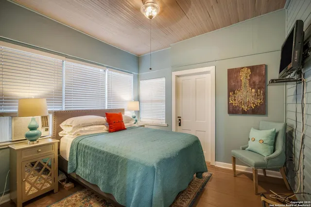 a bedroom with a bed and a chandelier