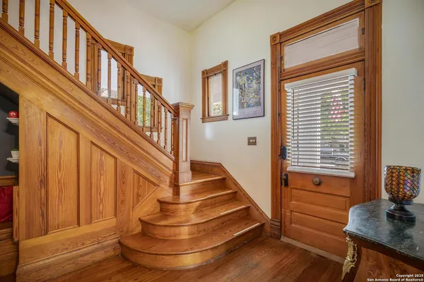 a view of entryway with wooden floor and a front door