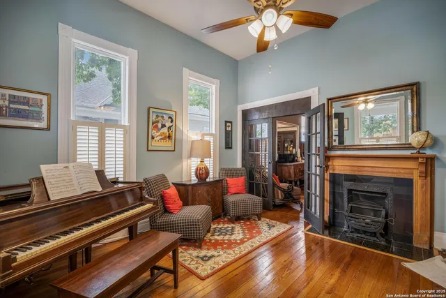 a living room with furniture fireplace and window