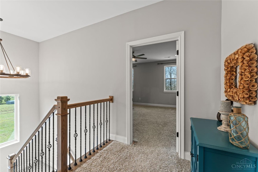 2425 Middleboro Road Clarksville, OH 45113 - Photo 61 of 91 This inviting hallway features a grand staircase and a spacious room beyond, offering comfort and style.