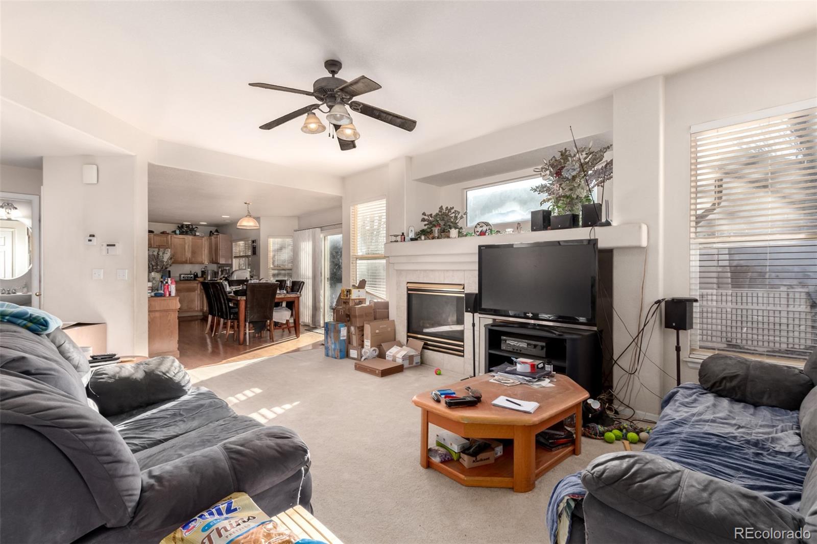 6542 Silverleaf Court Firestone, CO 80504 - Photo 3 of 18 a living room with furniture and a flat screen tv