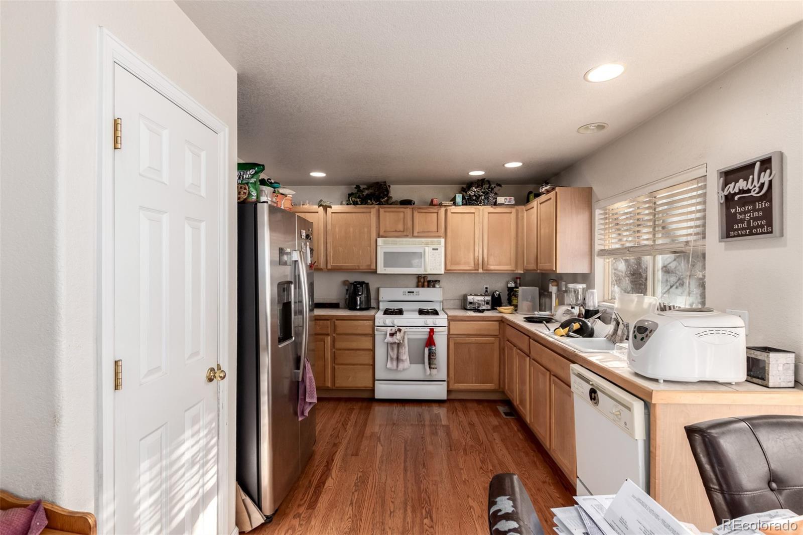 6542 Silverleaf Court Firestone, CO 80504 - Photo 5 of 18 a kitchen with a sink stove and cabinets
