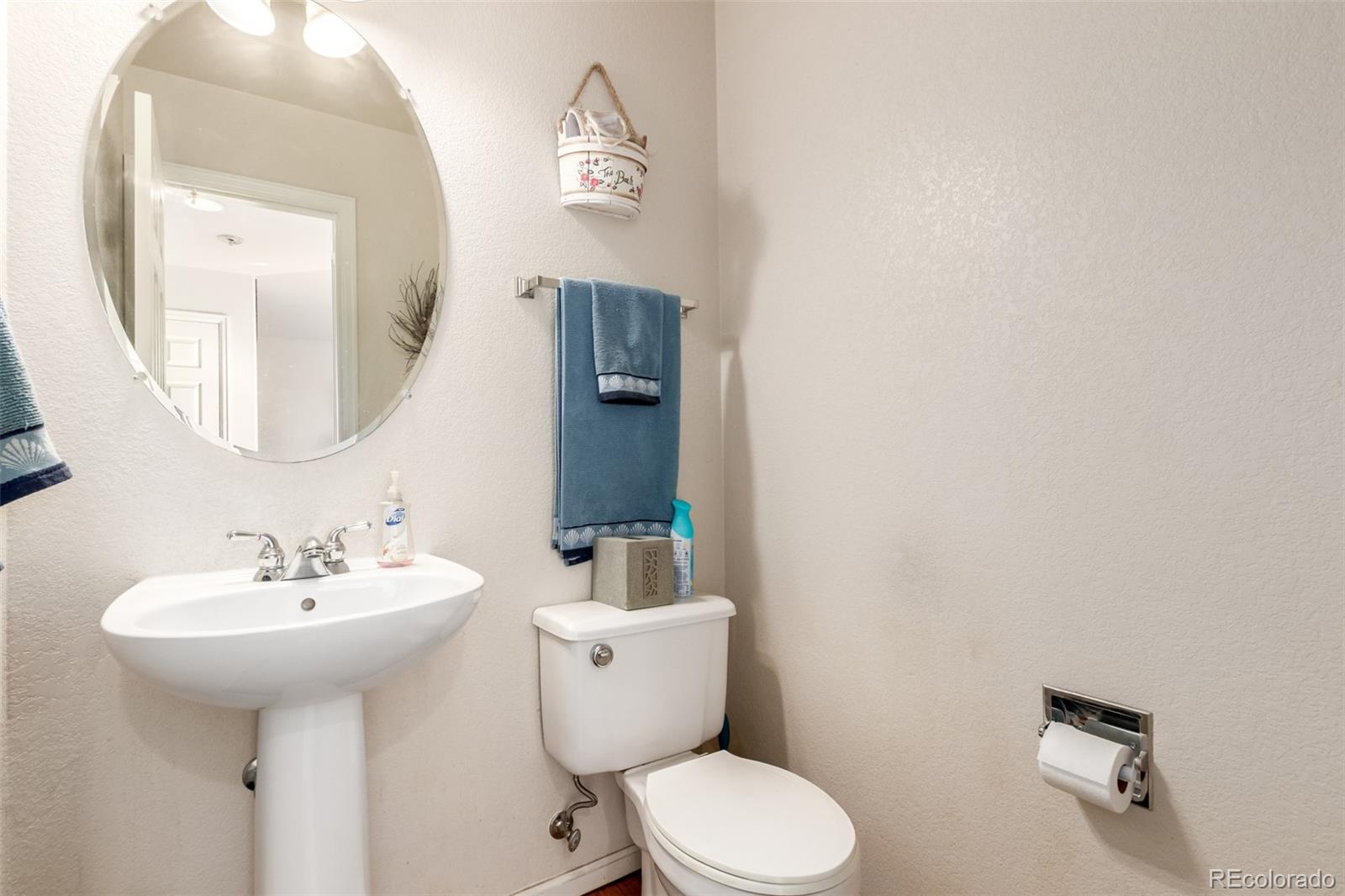 6542 Silverleaf Court Firestone, CO 80504 - Photo 7 of 18 a bathroom with a toilet sink and mirror