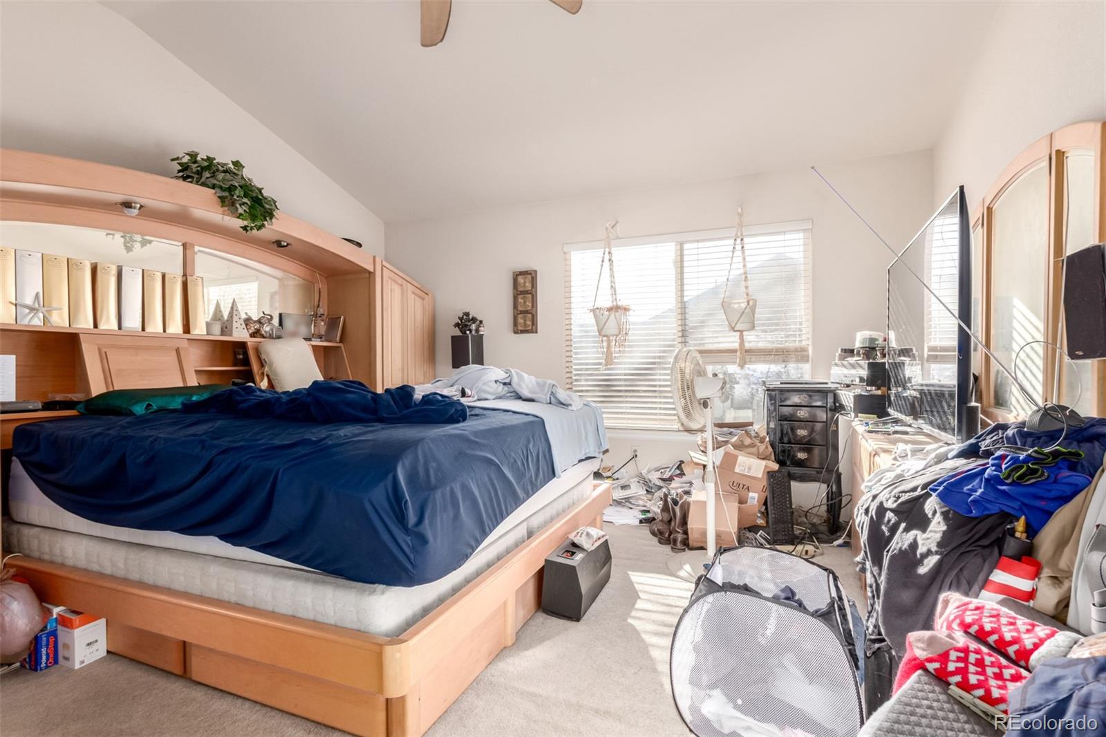 6542 Silverleaf Court Firestone, CO 80504 - Photo 9 of 18 a spacious bedroom with a bed and a chandelier