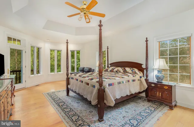 a living room with furniture and a book shelf