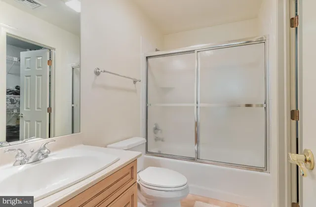 a room with furniture pool table wooden floor and windows