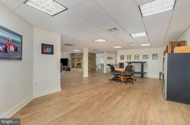 an aerial view of residential house with outdoor space and trees all around