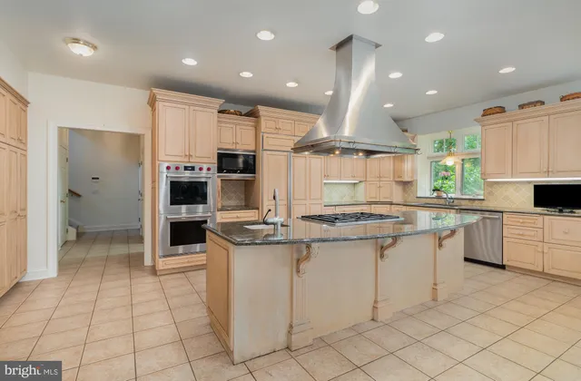 a kitchen with stainless steel appliances granite countertop a sink and cabinets