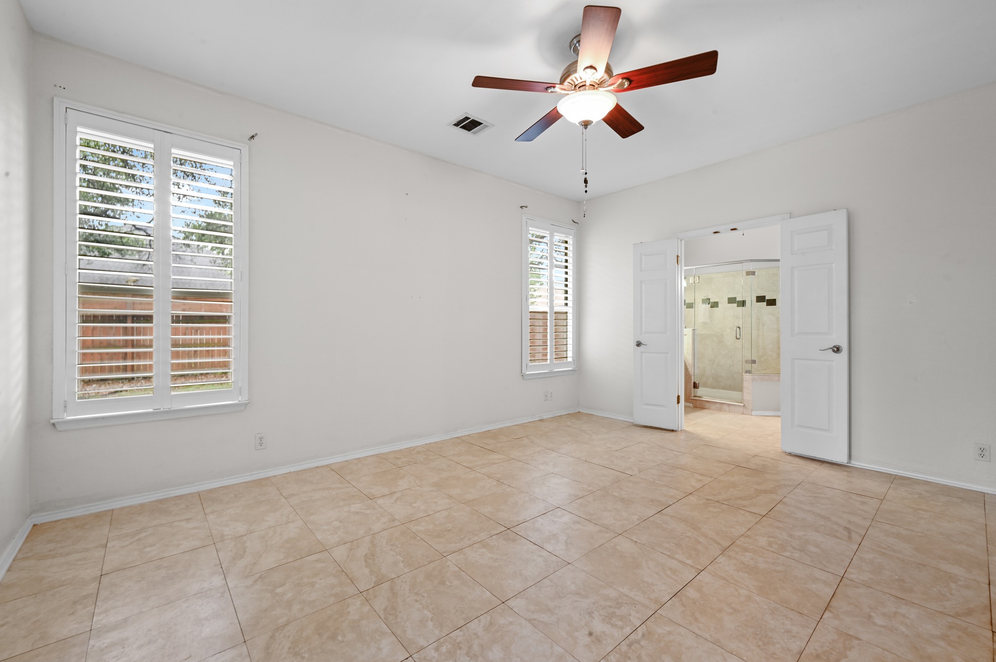 5313 Moon Shadow Drive Austin, TX 78735 - Photo 20 of 30 Spacious room featuring tile flooring, white walls, and a ceiling fan with integrated lighting