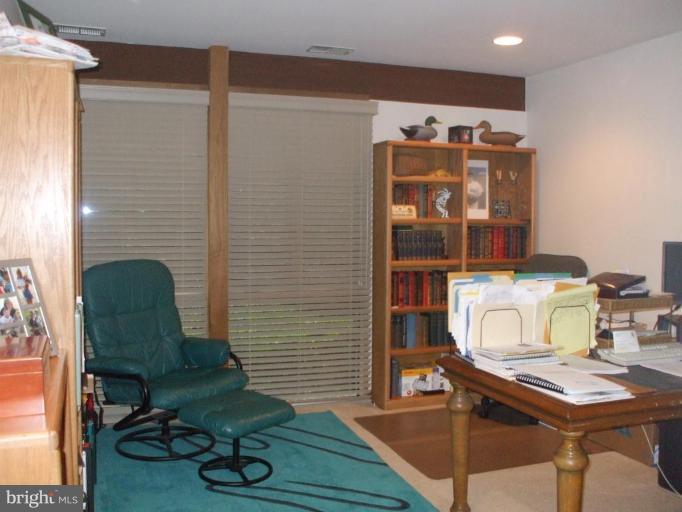 686 Discovery Road Davidsonville, MD 21035 - Photo 12 of 30 a view of a workspace with furniture and wooden floor