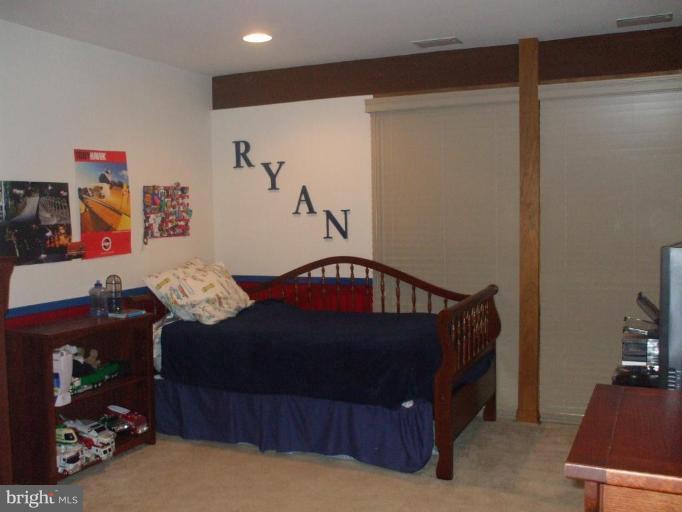 686 Discovery Road Davidsonville, MD 21035 - Photo 13 of 30 a bedroom with a bed and a dresser in it