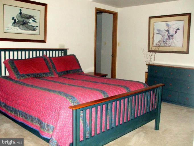 686 Discovery Road Davidsonville, MD 21035 - Photo 14 of 30 a bedroom with a bed and a painting on the wall