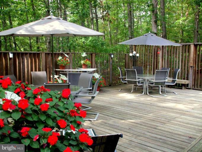 686 Discovery Road Davidsonville, MD 21035 - Photo 19 of 30 a patio with table and chairs under an umbrella
