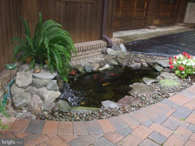 686 Discovery Road Davidsonville, MD 21035 - Photo 20 of 30 a view of a backyard with plants and flowers