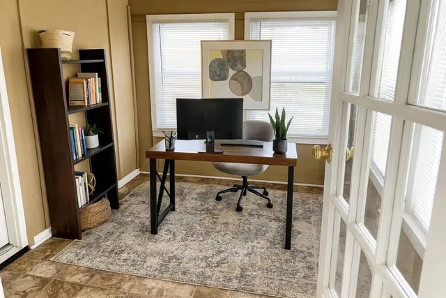 a view of a livingroom with furniture and a window