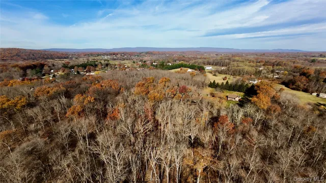 an aerial view of residential building and trees around