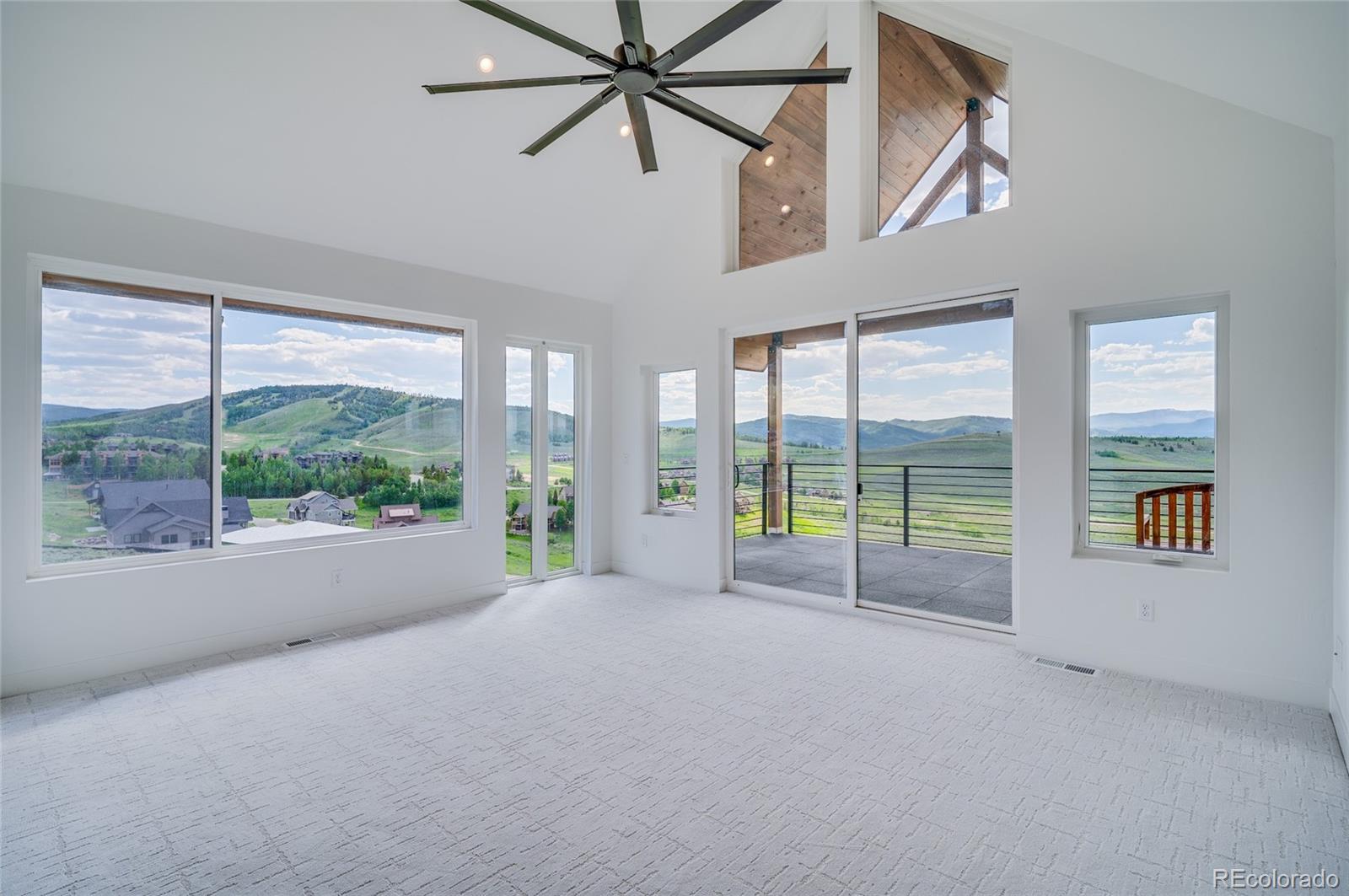 561 Upper Ranch View Drive Granby, CO 80446 - Photo 17 of 44 a view of an empty room with windows and a balcony