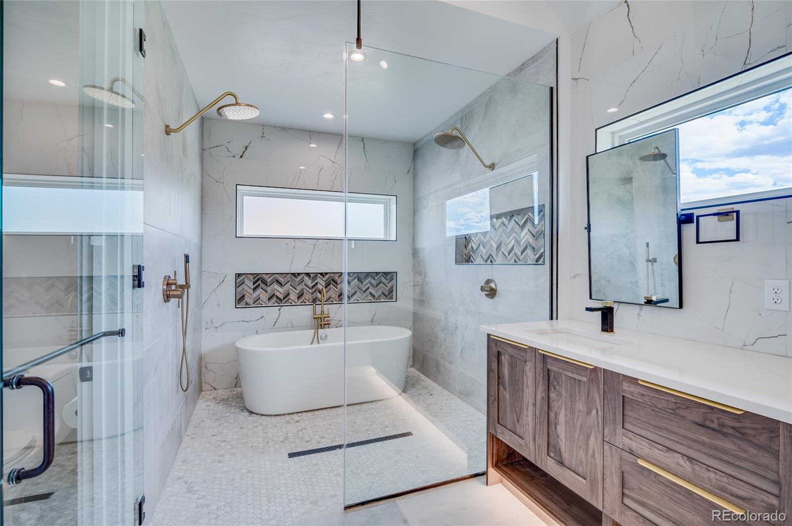 561 Upper Ranch View Drive Granby, CO 80446 - Photo 20 of 44 a spacious bathroom with a double vanity sink a mirror a bathtub and shower
