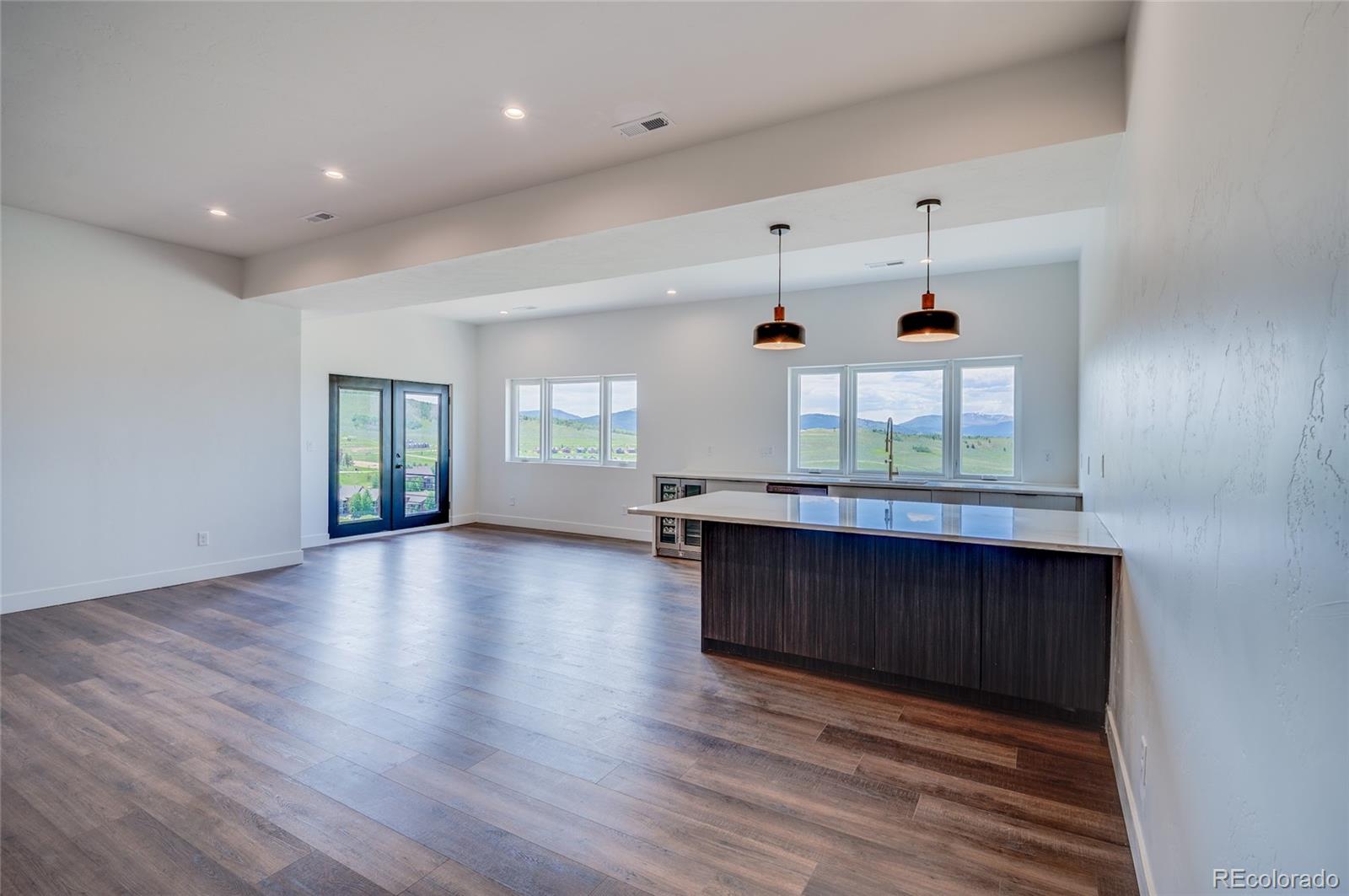 561 Upper Ranch View Drive Granby, CO 80446 - Photo 23 of 44 a view of an empty room with wooden floor and a window