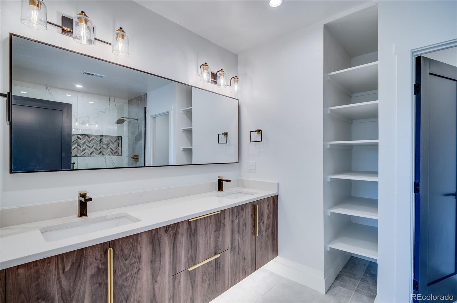 561 Upper Ranch View Drive Granby, CO 80446 - Photo 32 of 44 a bathroom with a double vanity sink and mirror