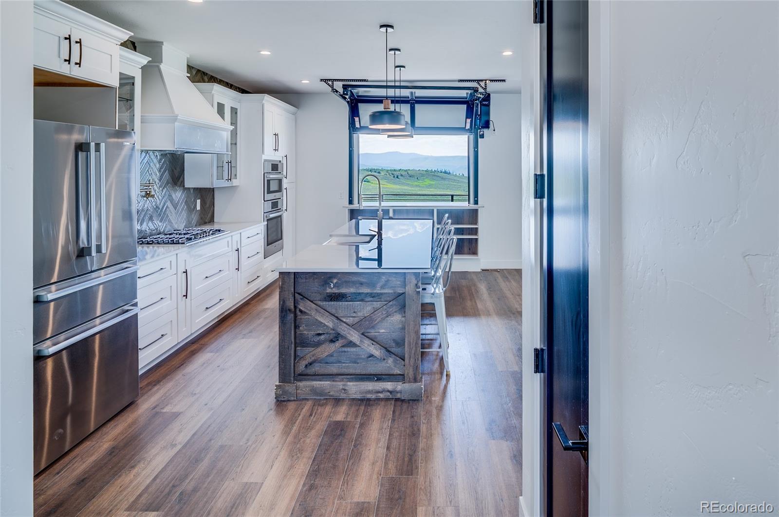 561 Upper Ranch View Drive Granby, CO 80446 - Photo 5 of 44 a kitchen with stainless steel appliances granite countertop a refrigerator and a stove