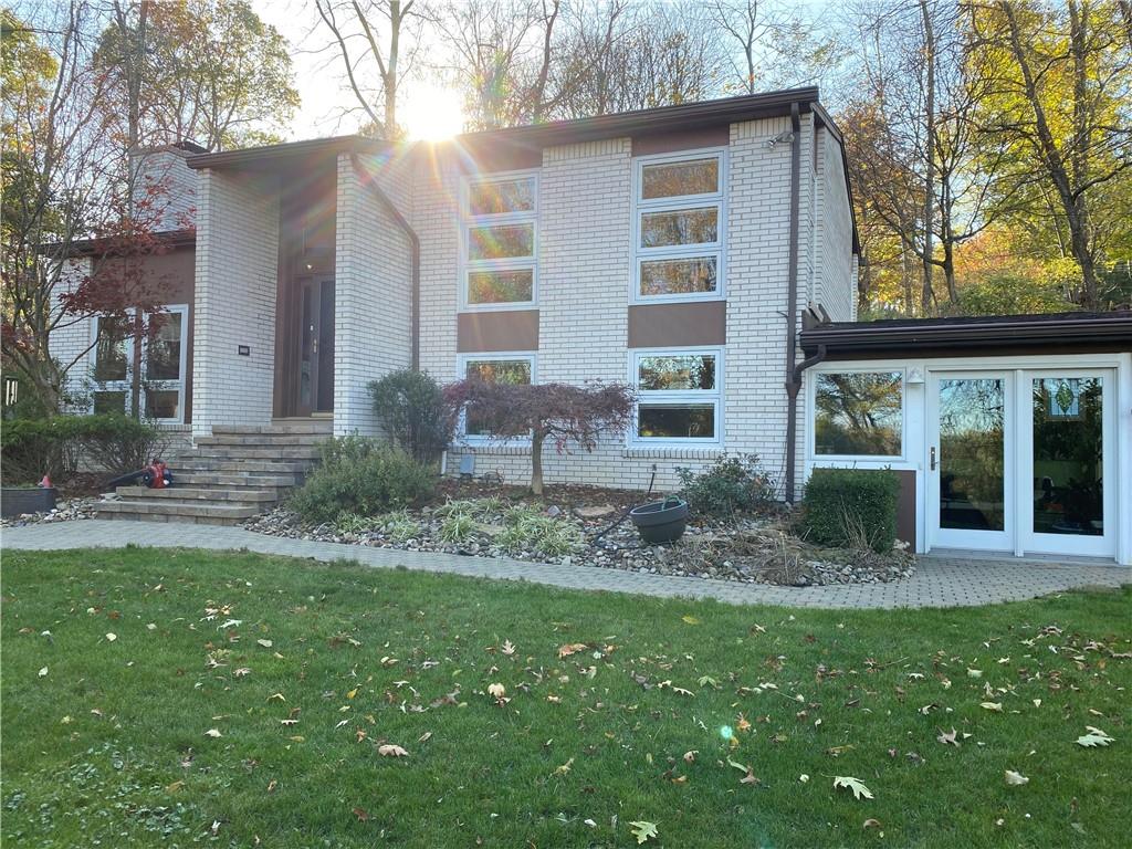 Brick split entry home on 1 acre of property with sun room