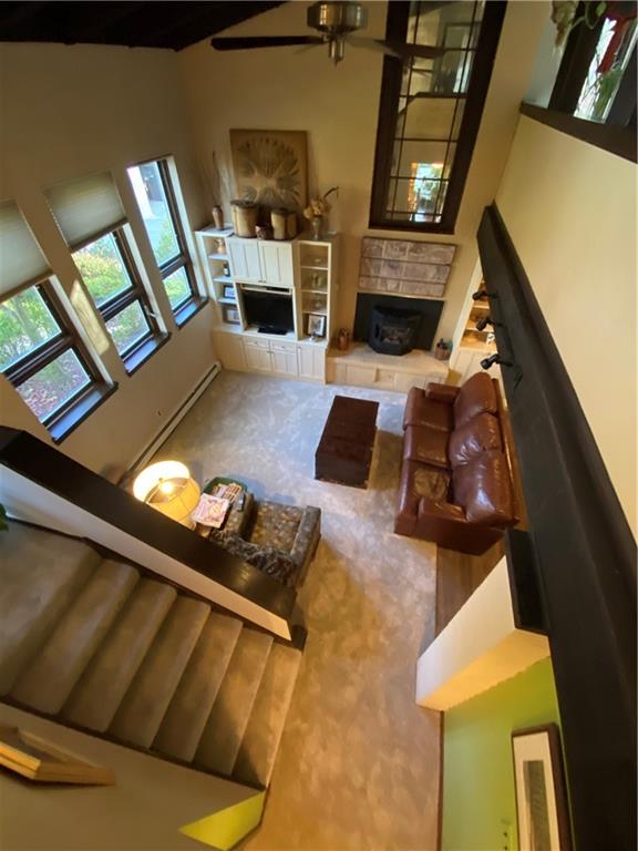 Cathedral ceiling - this photo of living room with pallet stove was taken from the stairway. Lots of light filtering through the triple pane windows