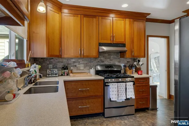a kitchen with a stove a sink and a refrigerator